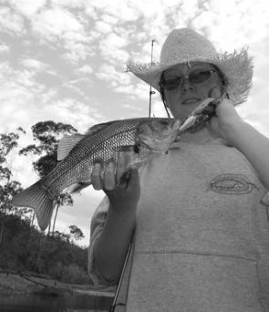 The author’s daughter with a Brogo Dam bass. Look for those lovely balmy nights when the insect life is very active and surface fishing is at its best.